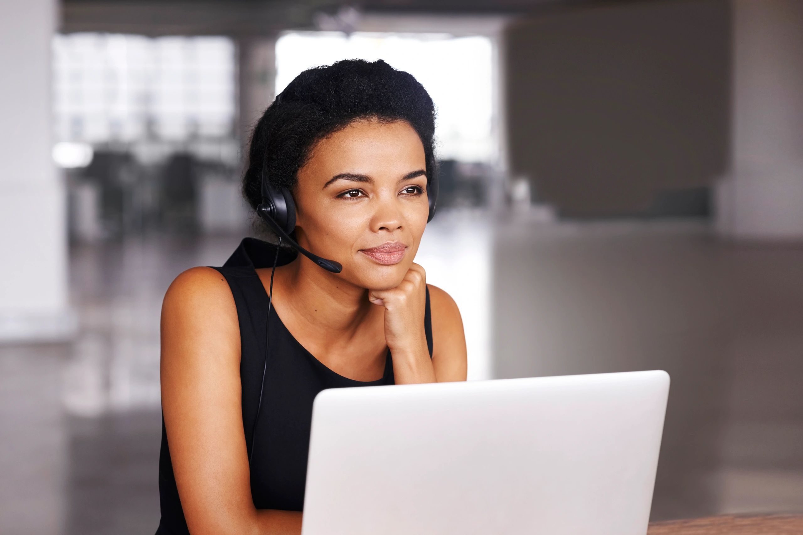 Support agent at a desk wearing a headset